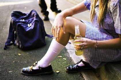 Schoolgirl in uniform and t-bars school shoes drinking and smoking