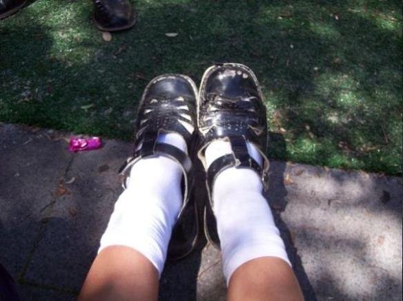 Schoolgirl wearing a scuffed pair of Harrison Idaho t-bars with white socks